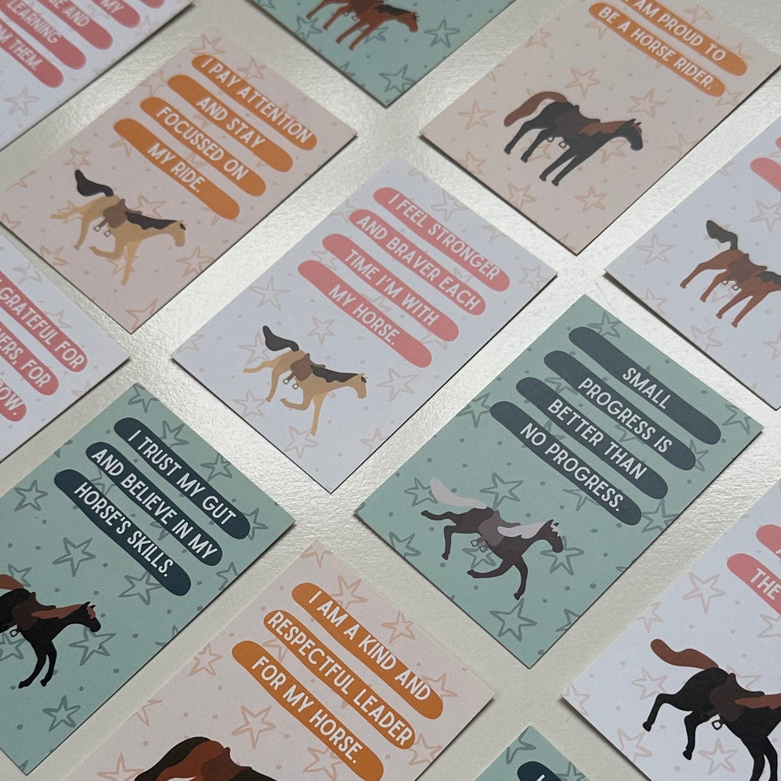 Set of cards with horse illustrations and text on a white surface